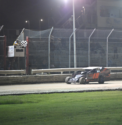 Blayden Arquette (18) takes the checkered flag in the Christ Frennier Motorsports Limited Sportsman 