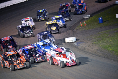 Joshua Pete (84P) leads the pack on turns 3 and 4 in the Crossroads Tobacco Sportsman Modifieds A Ma