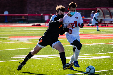 Plattsburgh's Simon Meyer and Beekmantown's Dalton Kane engage in a physical battle for the ball